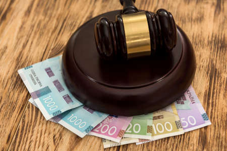 Uah, ukraine money with wooden gavel, law conceptの写真素材