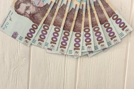 different ukraine money 1000 and 500 bills lying on wooden desk. UAH. Save and money concept