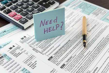 Tax form, pen and calculator at office desk. financial accountig