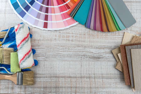 Tool paint palette and paintbrush, blue gloves for repair house. Home work backgroundの写真素材