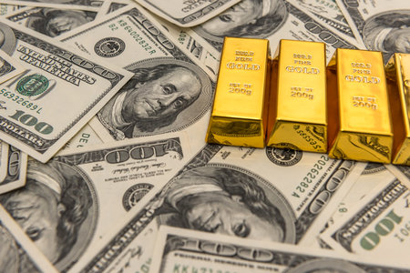 gold bullion bars on usd money bills. success concept. investment