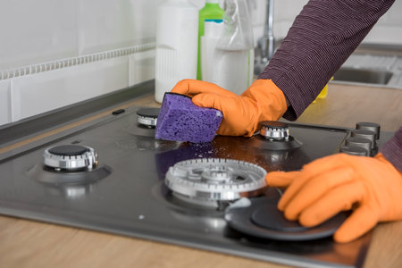 Cleaning in the kitchen gas stone with foam and sponge. domestic equipment for health lifestyleの写真素材