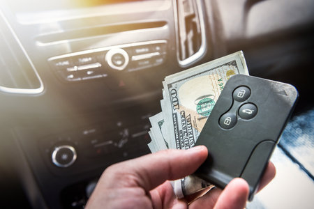 man hold dollar and car key for pay rent or bribe. finance