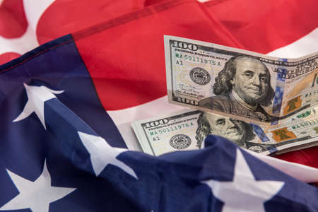american flag and dollar cash money as background of economy of USA. finance
