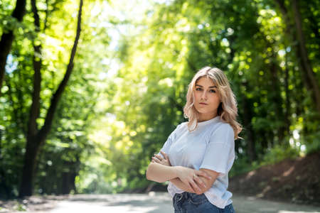 happy woman in forest enjoy free summer time over woods backgroundの写真素材
