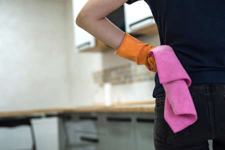 woman holding a rag in the kitchen and ready to clean. concept of cleanlinessの写真素材