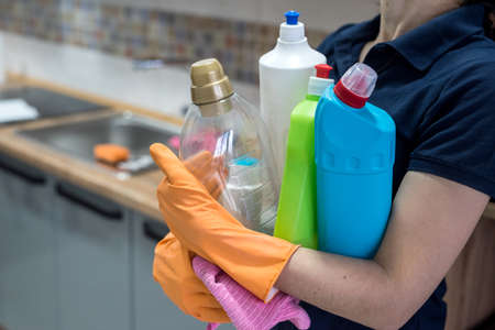 woman holding cleaning products and products and ready to clean. houseworkの写真素材