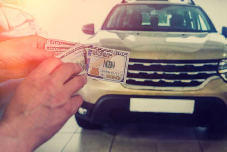 Money to buy the new car. financial concept. dollar in hand