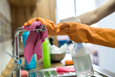 woman holding cleaning products and products and ready to clean. housework
