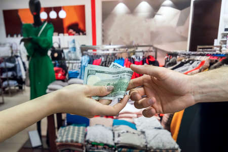 buying clothes in the store, the buyer pays money for purchases. lifestyle
