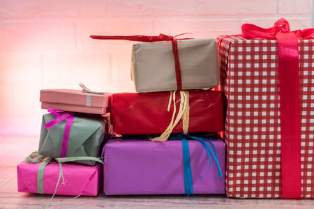 Ready for Christmas. Colorful presents on wooden table top viewの写真素材