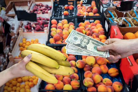 man who takes care of his health buys fruit in a store. healthy lifestyle conceptの写真素材