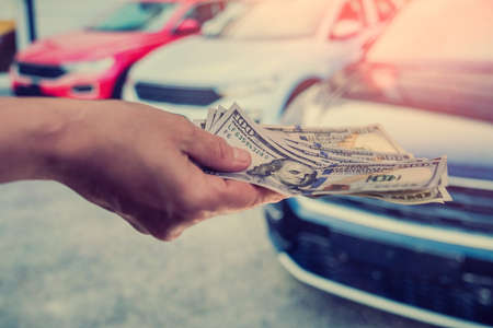 purchase new acr concept. man holding dollar for rent auto. financeの写真素材