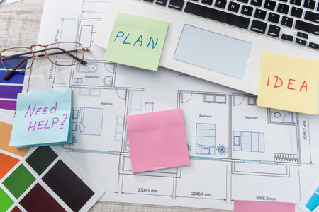 Creative work at office laptop with house sketch , calculator and color sampler. Architect design projectの写真素材