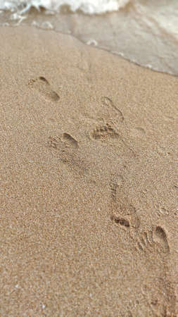 footprints on the sand by the sea. summer holidaysの写真素材