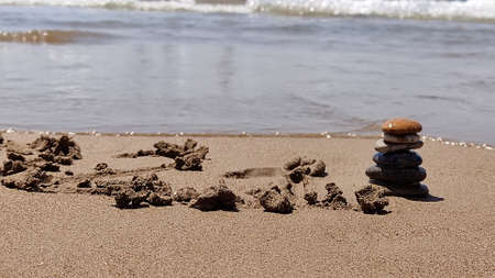 concept of balance sea rocks on sand symbolizing zen. summer holidays