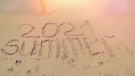 handmade written Summer 2021 on the sea beach. sea background
