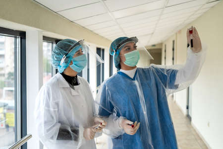 two nurses work with blood samples to determine the outcome of a coronavirus infection. teamwork