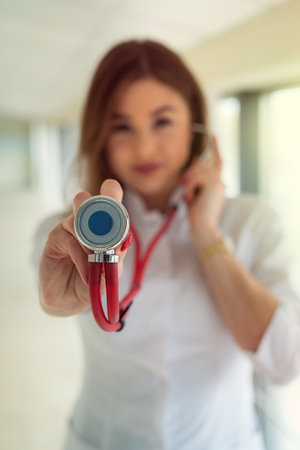 Female medical healthcare staff with stethoscope in modern clinicの写真素材