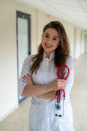 Female medical healthcare staff with stethoscope in modern clinicの写真素材