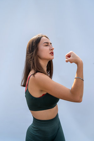 portrait of fitness woman in sportswear posing isolated on gray background. health and sport conceptの写真素材