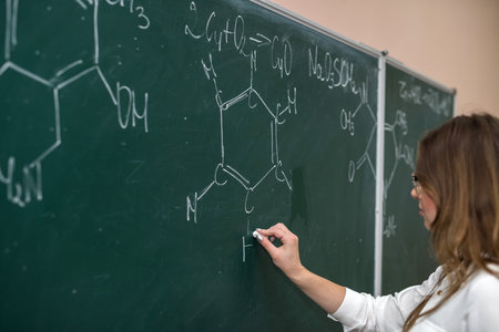female science student with glasses explain chemistry lesson at school. Educationの写真素材