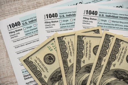dollar bills on 1040 tax form. financial concept. 2020の写真素材