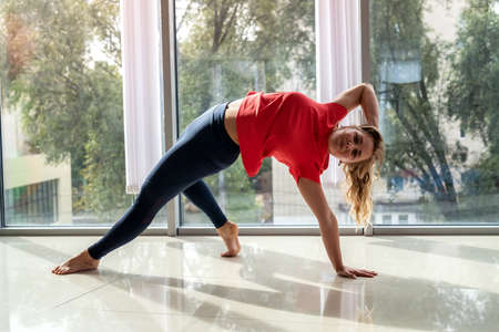 Beautiful young sporty woman practicing yoga for health back. Sport as lifestyleの写真素材