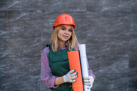 portrait of woman builder worker standing wear uniform and helmer. Home renovation.の写真素材