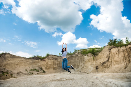 beautiful girl walking on the sand with blue sky. Perfect summer sunny day for vacationの写真素材