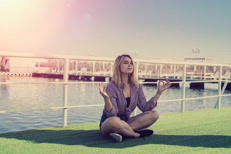 portrait of pretty teenage girl in near a city pond, summer time, vacationの写真素材