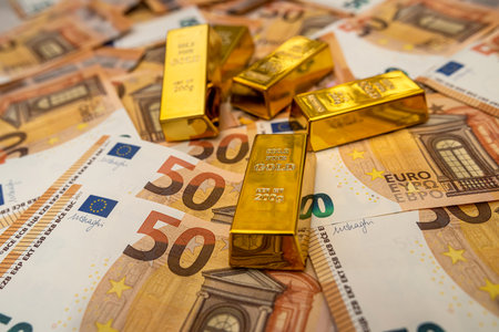 Big amount of 50 euro money banknotes and gold bullion saving conceptの写真素材