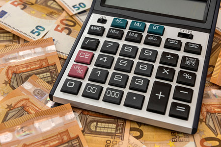 pile of euro cash and calculator as finance backgroundの写真素材