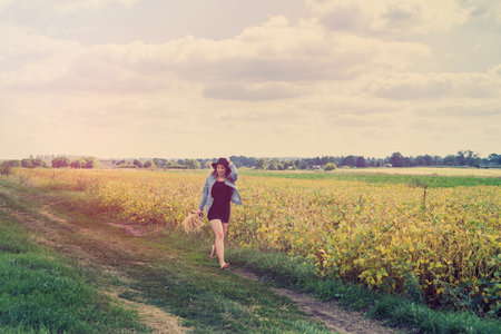 Beautiful carefree woman posing in rural fields in summer. lifestyleの写真素材