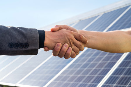 Foreman and businessman shaking hands after meeting and over deal their agreement or contract. soar panel. green electricityの写真素材