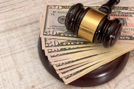 wood judge gavel and dollar, legal court system