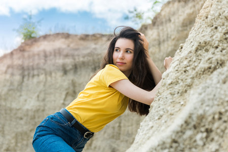 Young lady in casual cloth relax on sand rocks, summer timeの写真素材