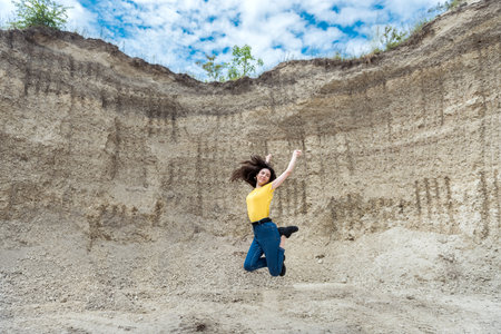 female model in casual cloth walk in sand quarry and enjoy summer lifestyleの写真素材