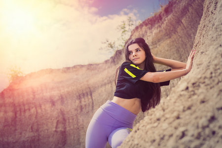 woman posing in background of mountain of sand, summer lifestyle, beauty of natureの写真素材