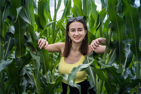 portrait of beautiful girl posing in green corn field, enjoy summer free time