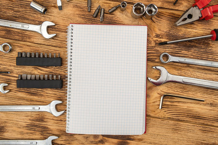 Empty notepad surrounded by a set of construction tools. Equipment for repair. Workplace