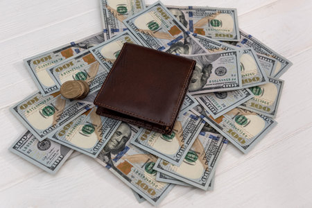 us dollar into dark leather wallet, finance concept