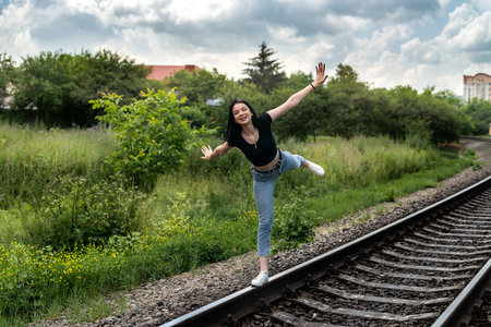 Young woman standing on a railroad, travel by train in summer holiday.の写真素材