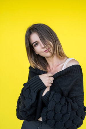 portrait of a beautiful young woman near the yellow wall. lifestyleの写真素材