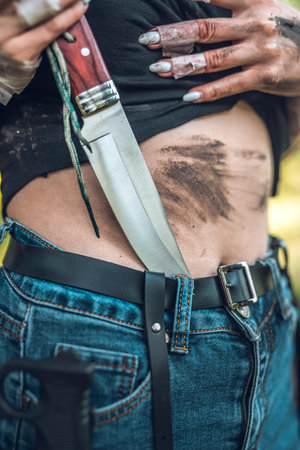 sharp knife in female hand at outdoor, warrior
