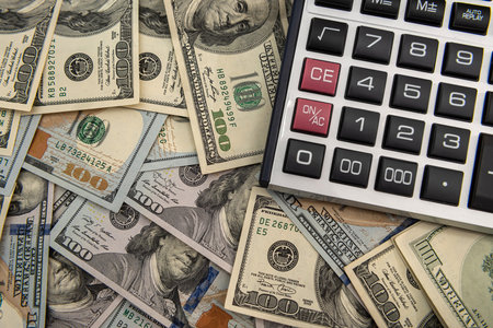 US dollar bills and calculator, investment or saving conceptの写真素材