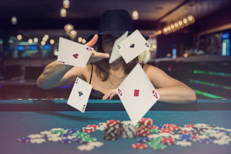 Sexy woman playing poker in elegant black dress at clubhouse. gambling conceptの写真素材