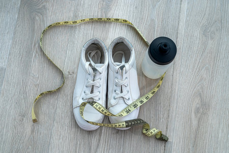 colored dumbbells for sports ball with sand sneakers gum for sports and cubes spread out on the...