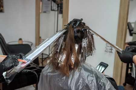 in the elite basic beauty salon they make a wonderful hair dye for a refined lady with dark hair. Woman hair concept. beauty service conceptの写真素材