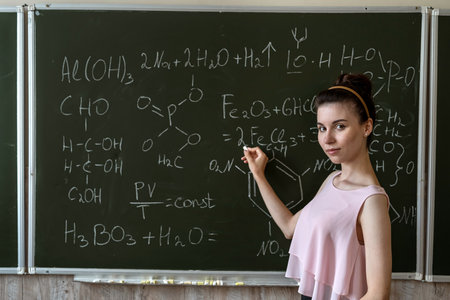 teacher of chemistry against blackboard explane chemical formula, education conceptの写真素材
